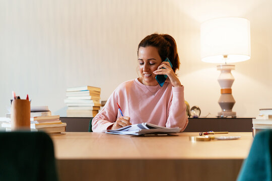 Hispanic woman taking on smartphone