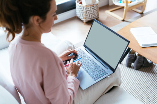 Woman working on laptop remotely