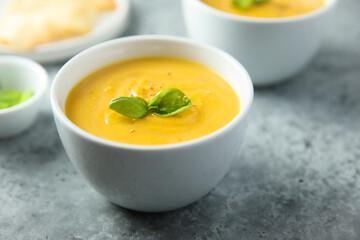 Traditional homemade pumpkin soup with fresh basil