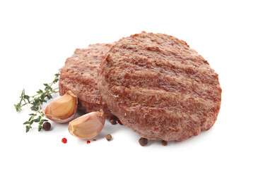 Tasty grilled hamburger patties with seasonings on white background