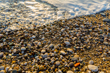 sea ​​water on stones pebbles on the sea
