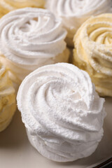 White and yellow delicious zephyrs on plate, closeup