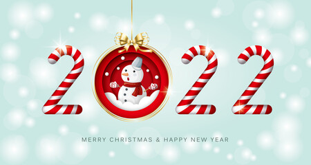 Merry Christmas and happy new year 2022 banner with candy cane, bauble and snowman on light green background.