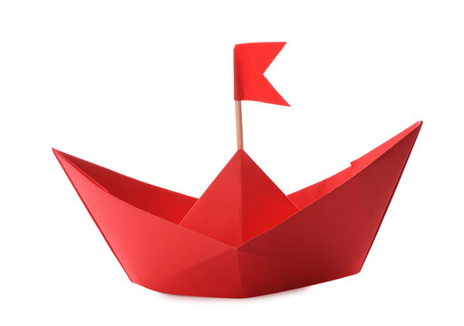 Handmade red paper boat with flag isolated on white. Origami art
