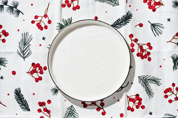 Served christmas table setting in white and red tones. White plate on white background.