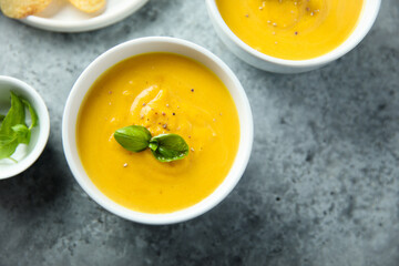 Traditional homemade pumpkin soup with fresh basil