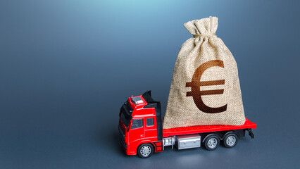 Truck with a euro money bag. Loan or deposit. Financial aid, investments and subsidies....