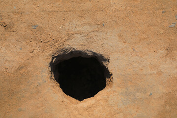 Hole in the ground, close-up photo