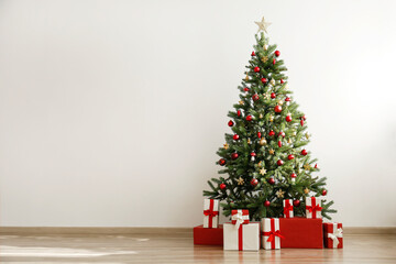 Traditional christmas pine tree with holiday decorations, copy space for text. Decorative lights...