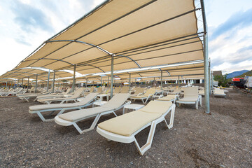 sun loungers with awnings by the sea