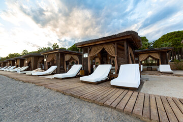 wooden bungalows with white sun loungers