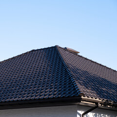 The roof is made of brown metal tiles, a large house.