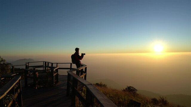 Slow motion of Photographer take a photo to sunset at Kew Mae Pan viewpoint in Doi inthanon, Chiang Mai, Thailand.