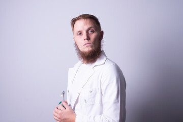 Male doctor in laboratory coat on gray background