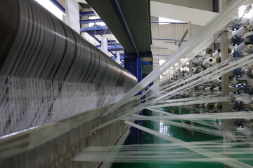 Naklejka premium The mechanical equipment of the plastic weaving production line is running in a factory