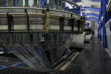 The mechanical equipment of the plastic weaving production line is running in a factory