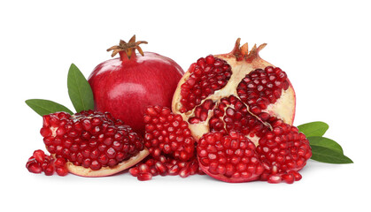 Tasty ripe pomegranates and leaves on white background