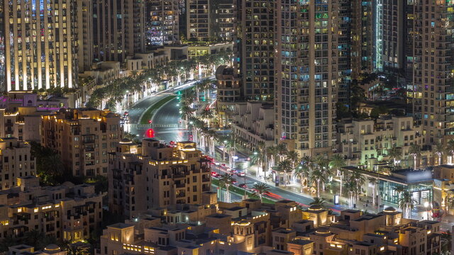 Intersection traffic night timelapse on Mohammed Bin Rashid Boulevard curves among the many illuminated skyscrapers and towers