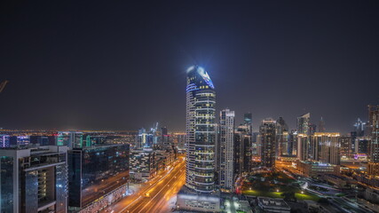 Fototapeta na wymiar Panorama showing Dubai's business bay towers aerial night timelapse. Rooftop view of some skyscrapers