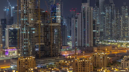 Fototapeta na wymiar Dubai's business bay towers aerial night timelapse. Rooftop view of some skyscrapers