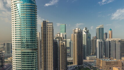 Fototapeta na wymiar Dubai's business bay towers aerial morning timelapse. Rooftop view of some skyscrapers