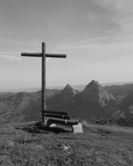 Bench and cross on top of Mount Fronalpstock.
