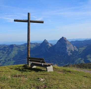 Bench and cross on top of Mount Fronalpstock.