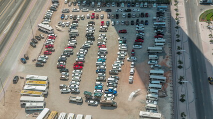 Aerial view of a parking lot with many cars in rows timelapse