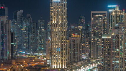 Futuristic aerial all night cityscape timelapse with illuminated architecture of Dubai downtown, United Arab Emirates.