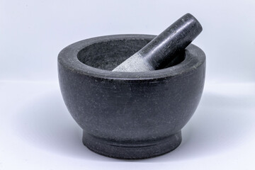 Selective focus of black marble or granite mortar and pestle on white background, Cooking tools in...