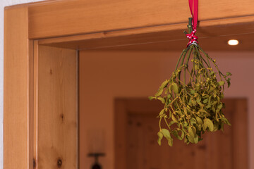 mistletoe hanging from door frame for kissing