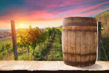 Red wine with barrel on vineyard in green Tuscany, Italy