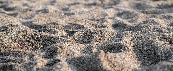 Background texture of beach loose sand with soft focus. Banner