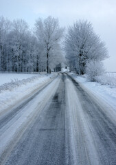 Fototapeta na wymiar Icy and snowy weather, hazardous road and driving conditions, traffic disruption 