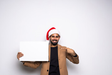 young man in a Santa Claus hat with white board with space for text isolated on white background