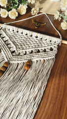Fototapeta premium Macrame home decoration wall hanger photo handmade, white color with wooden pieces 