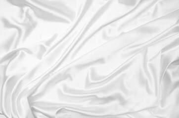 Creases of white satin, silk, and cotton. Abstract white fabric texture background.