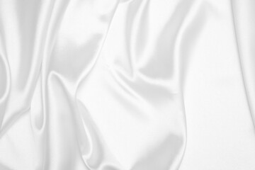 Creases of white satin, silk, and cotton. Abstract white fabric texture background.