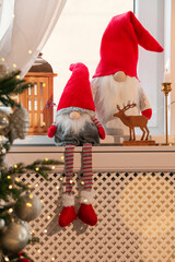 Obraz premium Cute Christmas gnomes on windowsill in room