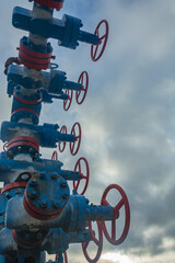 Gas well spout fittings with high-pressure valves and round hand wheels to regulate the flow of gas...