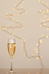 A glass of wine, champagne with envelope against bokeh background close up. Top view. New Year, Christmas mood. Greeting card. Party and holiday celebration concept.