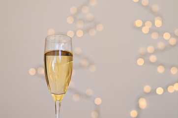 A glass of wine, champagne with envelope against bokeh background close up. Top view. New Year, Christmas mood. Greeting card. Party and holiday celebration concept.