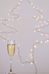 A glass of wine, champagne with envelope against bokeh background close up. Top view. New Year, Christmas mood. Greeting card. Party and holiday celebration concept.