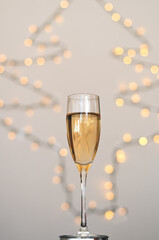 A glass of wine, champagne with envelope against bokeh background close up. Top view. New Year, Christmas mood. Greeting card. Party and holiday celebration concept.