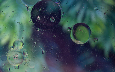 Bubble on water abstract bakgrounds. Murmur of oil on water, unusual abstraction. Macro. Abstraction of the cosmos. Water drops on a colored texture background.