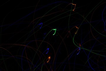 Multicolored neon lights on black background