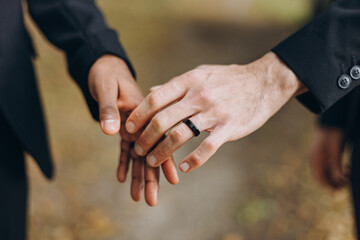 European Gay Couple holding hands, homosexual marriage wedding day. Gentle touch of a same sex couple