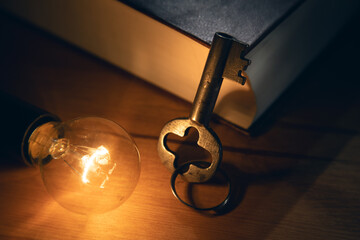 key with lightbulb over book