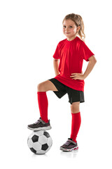 Full-length portrait of girl, child, football player in red uniform training, posing isolated over white background © Lustre Art Group 