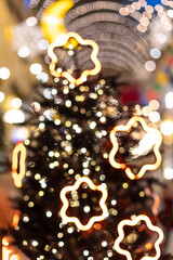 Christmas tree in Christmas decorations and bright lights. Unsharp image, defocus, blair. Garland lights in bokeh
